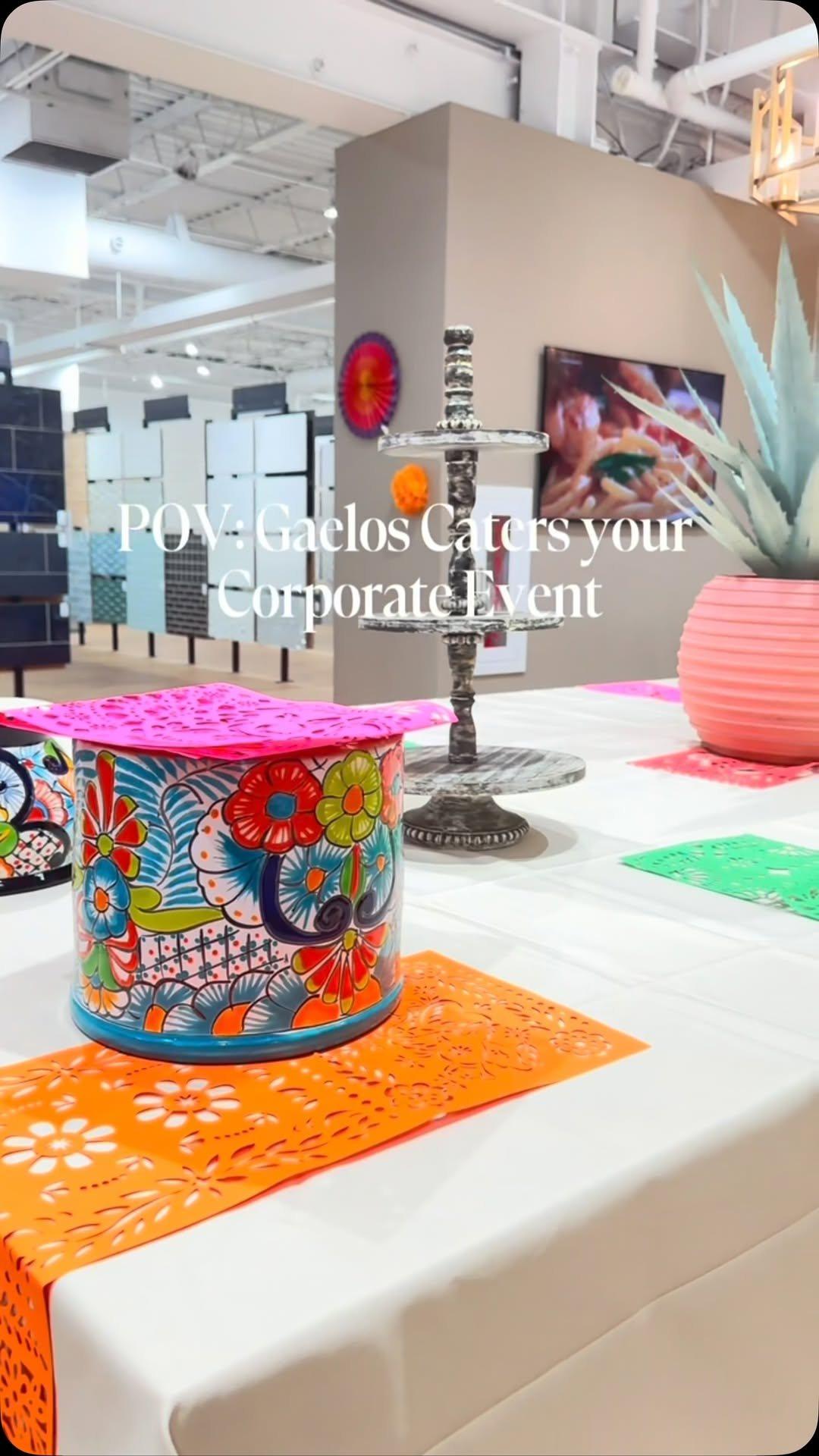 A corporate event table set by Gaelos with a talavera centerpiece and orange papel picado